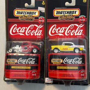 Two new in box Coca Cola cars